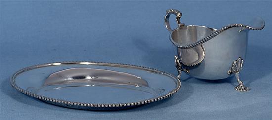 A 1950s/1960s silver sauce boat and similar stand, by Adie Brothers, stand length 206mm, weight 11.8oz/370grms.